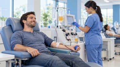 Plasma donor relaxing in a reclining chair during a donation at a bright plasma center