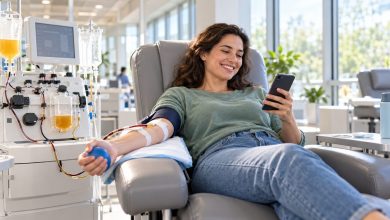 Smiling adult donor relaxing in a reclining chair during a plasma donation at a bright, modern donation center