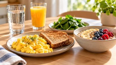 Healthy breakfast with eggs, whole-grain toast, oatmeal with berries, spinach, water and orange juice before a plasma donation